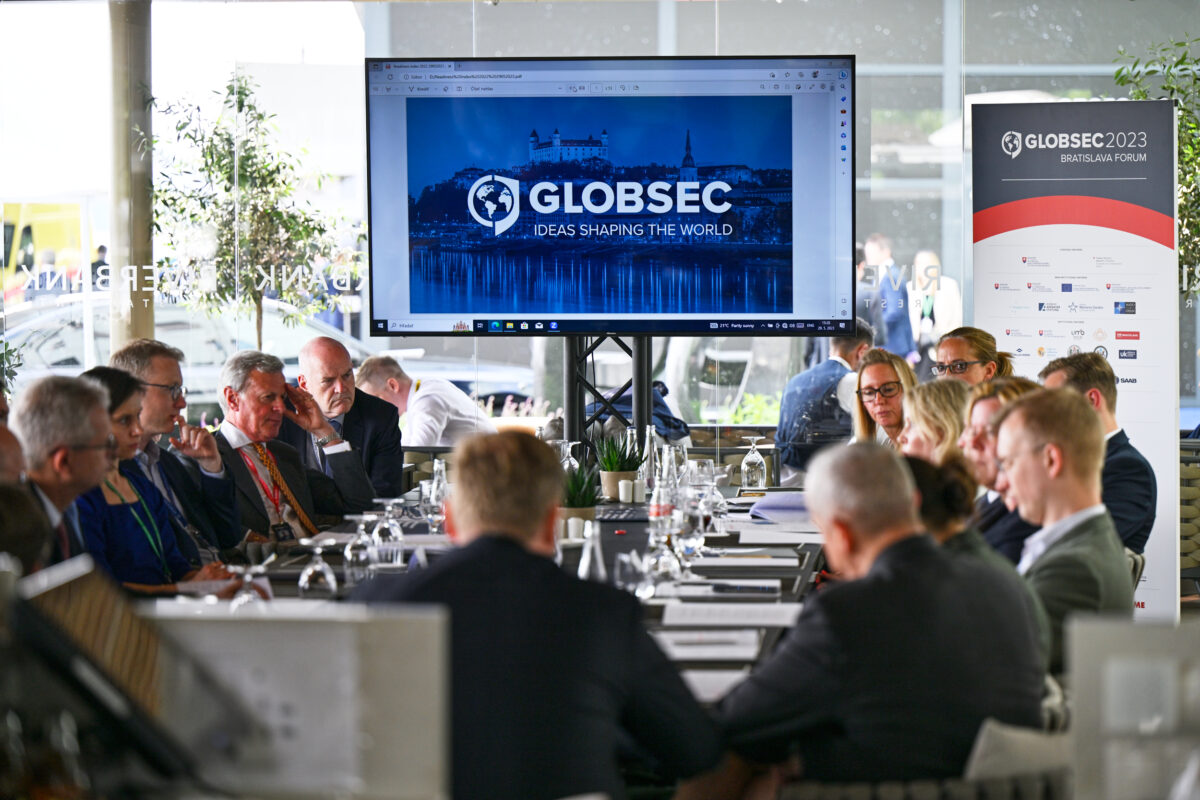 Group of experts engaged in a roundtable discussion on European security challenges at a GLOBSEC side session.